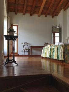 a bedroom with a bed and a table and chairs at Chalet Lilia in Brienno
