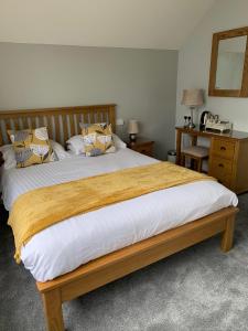 a bedroom with a large bed with pillows on it at Chy an Gwedhen in St Ives