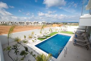 a swimming pool on the balcony of a resort at Olivine Pearl Villas in Protaras