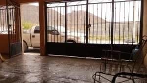 un cancello con un'auto parcheggiata in un parcheggio di Casa 4-100-egas a Cuatrociénegas de Carranza