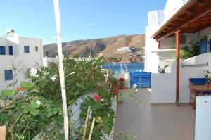 a balcony of a house with a view of the ocean at Aegeon Pension in Aegiali