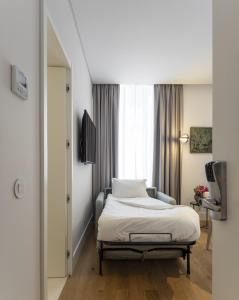 Ένα ή περισσότερα κρεβάτια σε δωμάτιο στο Lisbon Serviced Apartments - Madalena