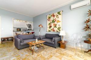 a living room with a couch and a table at Appartement Bagatelle Exceptional location with stunning sea views in Juan-les-Pins