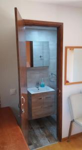 a bathroom with a sink and a mirror at XeniCamp & Bungalows in Tolo