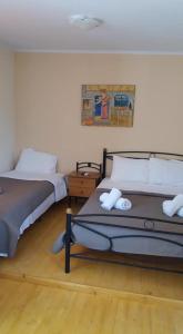sypialnia z 2 łóżkami i obrazem na ścianie w obiekcie XeniCamp & Bungalows w mieście Tolo