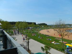 a group of people laying on the grass at a beach at Ferienwohnung Fränkisches Seenland - FeWo Antje in Mitteleschenbach