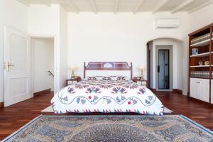 a bedroom with a large bed and a rug at Residence Estrela do Mar in Salema