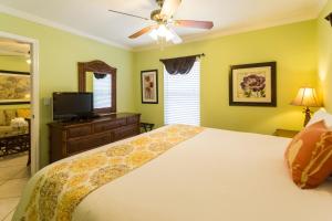 a bedroom with a bed and a television at Tropical Beach Resorts - Sarasota in Sarasota