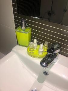 a bathroom sink with a faucet and a soap dispenser at Zurstrassen Apartment in Coimbra