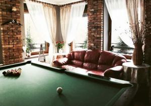 a living room with a pool table and a couch at Willa Kora in Szczyrk