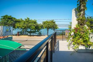 a view of the ocean from a balcony of a house at Pousada Porto do Itagua in Ubatuba