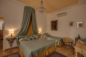 a bedroom with two beds and a chandelier at Florence Dream Domus in Florence