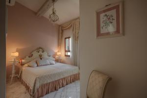 a bedroom with a bed and two lamps and a chair at Florence Dream Domus in Florence