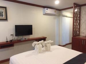 two elephants standing on a bed in a room at Nakhone Champa Hotel in Pakse