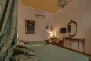a hotel room with two beds and a mirror at Florence Dream Domus in Florence