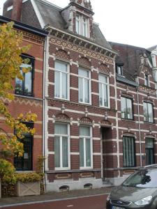 a brick building with a car parked in front of it at Op de Burg in Venlo