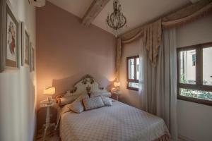 a bedroom with a white bed with two lamps and a window at Florence Dream Domus in Florence