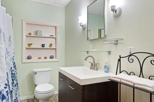 a bathroom with a sink and a toilet at White Lobster Cottage in Greenville +20 photos