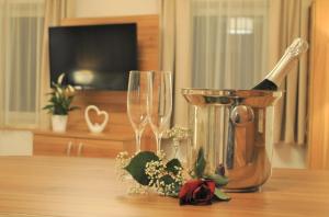 a bottle of champagne and two wine glasses on a table at Hotel Mauernböck in Rottenbach