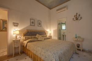 a bedroom with a bed in a room with two lamps at Florence Dream Domus in Florence