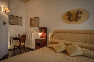 a bedroom with a bed and a table and a chair at Florence Dream Domus in Florence