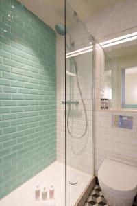 a bathroom with a toilet and a glass shower at Abbey Strand Apartments, at Holyrood in Edinburgh
