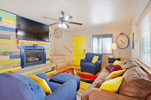 a living room with a couch and a fireplace at Cubbyz Cabin in Garden City