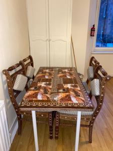 a dining room table with a table and chairs at Loch Lomond Apartments in Dumbarton