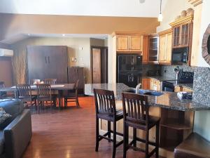 a kitchen and dining room with a table and chairs at PRC Annex - Pet Friendly in Canmore
