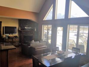 a living room with a table and a fireplace at PRC Annex - Pet Friendly in Canmore