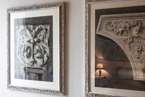 a framed picture of a painting on a wall next to a lamp at Florence Dream Domus in Florence