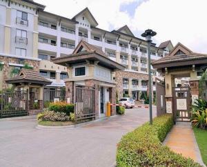 a large building with a parking lot in front of it at One Oasis Condo beside SM Mall in Davao City