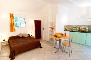 a bedroom with a bed and a table in a room at Villa Les Lieges de Palombaggia in Porto-Vecchio