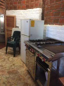 a kitchen with a stove and a refrigerator at Casa de las Olas in Mazunte +7 photos