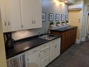 a kitchen with white cabinets and a sink at Koreana in Decorah in Decorah