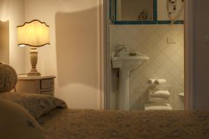 a bathroom with a bed and a sink and a lamp at Florence Dream Domus in Florence