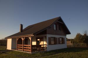 a small house with a black roof at Domek przy Gościńcu in Golczowice
