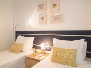 a bedroom with two beds with white pillows at Santos Stylish Cozy Apt – AC_Green Terrace in Lisbon