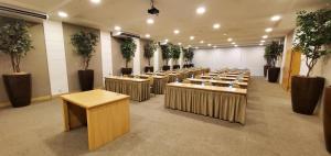 a row of tables in a room with potted plants at Atlantico Sul Hotel in Rio de Janeiro +95 photos