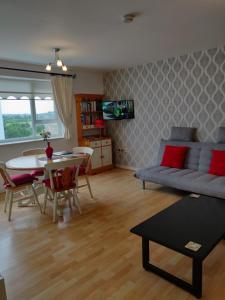 a living room with a couch and a table at Riverview Apartment in Skibbereen