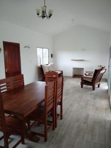 a dining room with a wooden table and chairs at Quijaneando in Campo Quijano