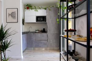 a small kitchen with white cabinets and a counter at B&B La Terrazza di Barbara in Milan