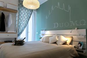 a bedroom with a large bed with a blue wall at B&B La Terrazza di Barbara in Milan