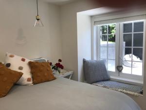a bedroom with a bed and a window and a chair at Villa @23 in Wanaka