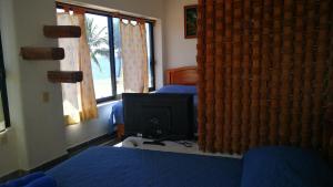 A bed or beds in a room at Pie de Playa la Ropa