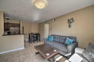 a living room with a couch and a table at Game Day Retreat with Pool Access 2 Mi to Texas AandM in College Station