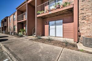 an apartment building with a large door on the side at Game Day Retreat Pool Access, 2 Mi to Texas A and M in College Station