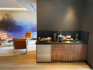 a kitchen with a counter and chairs in a room at LUXURY, meters to Lionshead Gondola. THE LION in Vail