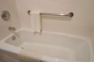 a white bath tub sitting next to a white toilet at Best Western China Lake Inn in Ridgecrest