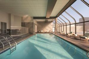 a large swimming pool with chairs in a building at Hyatt Regency Louisville in Louisville